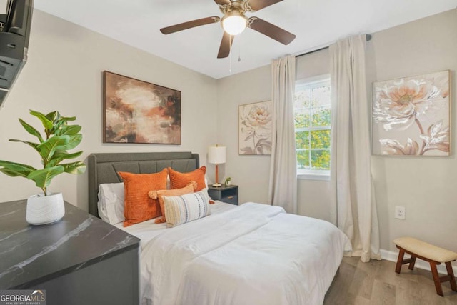 bedroom featuring wood-type flooring and ceiling fan