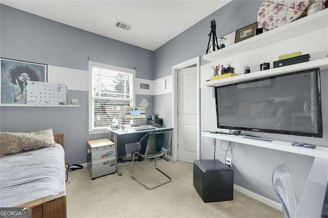 bedroom featuring built in desk and light carpet