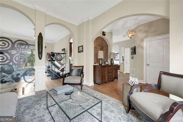 living room with ornamental molding and light hardwood / wood-style floors