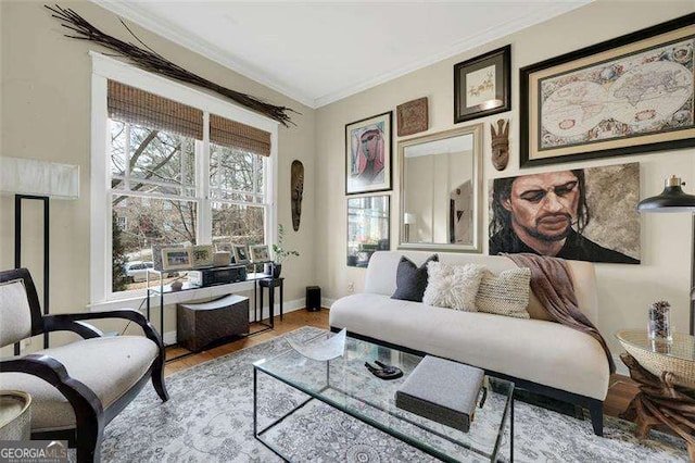 living area with crown molding and light hardwood / wood-style flooring