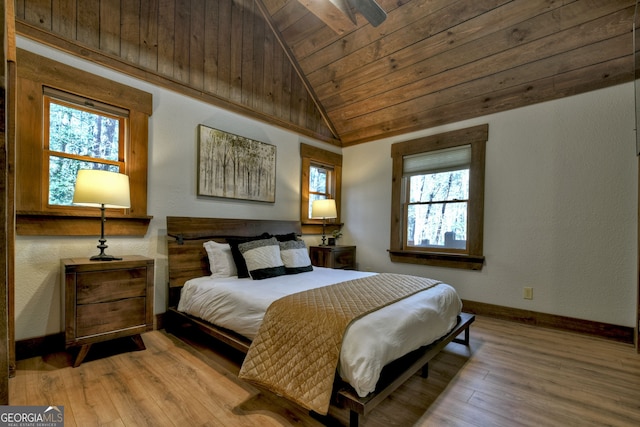 bedroom with vaulted ceiling, wood ceiling, and light hardwood / wood-style flooring