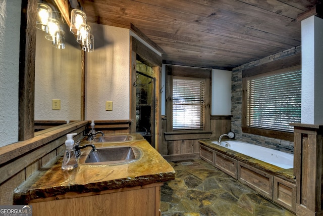 bathroom featuring vanity, a bathtub, and wooden ceiling