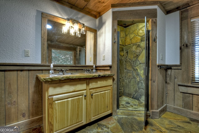 bathroom with walk in shower, wood walls, vanity, and wooden ceiling