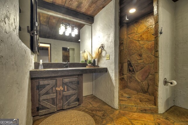 bathroom featuring walk in shower, vanity, beam ceiling, and wooden ceiling