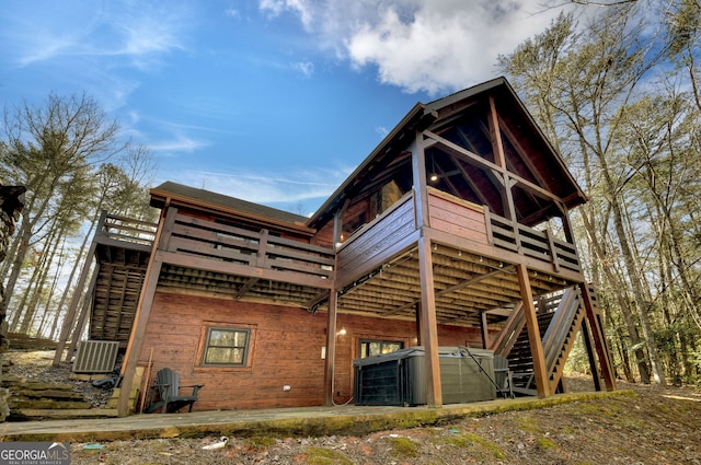 rear view of property featuring a deck