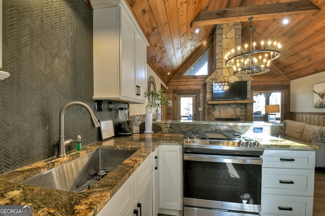 kitchen with white cabinetry, pendant lighting, sink, and stainless steel gas range oven