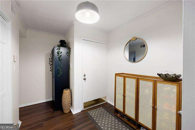 hallway featuring dark hardwood / wood-style flooring, ornamental molding, and a textured ceiling