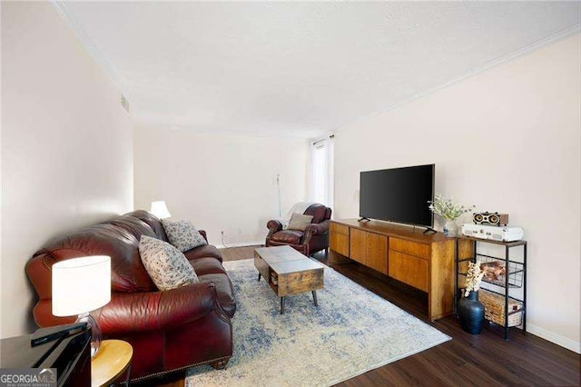 living room with dark wood-type flooring and ornamental molding