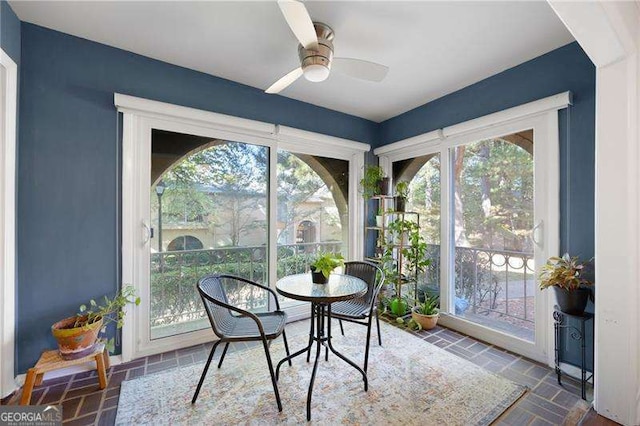 sunroom with plenty of natural light and ceiling fan