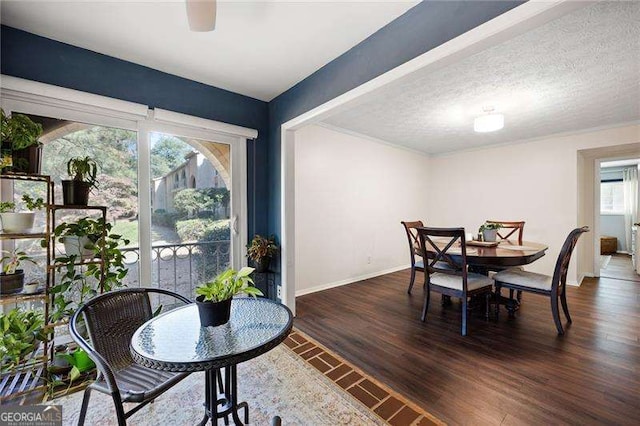 dining area with dark hardwood / wood-style flooring and a textured ceiling