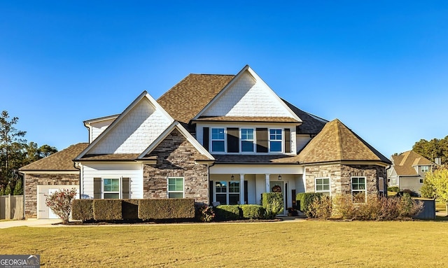 view of front of home with a garage and a front yard