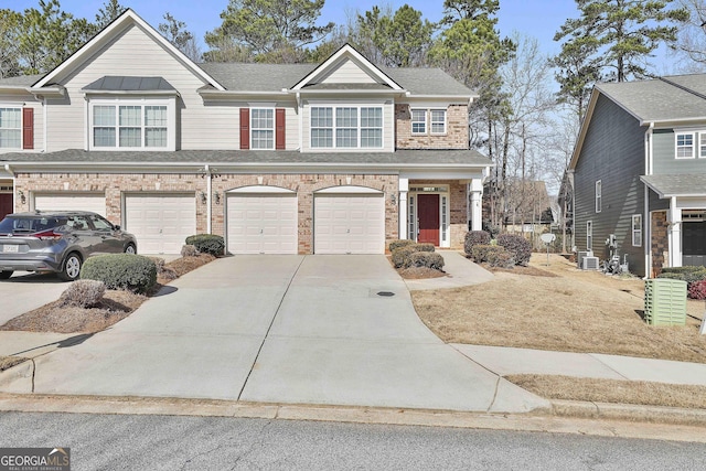 view of front of property with cooling unit and a garage