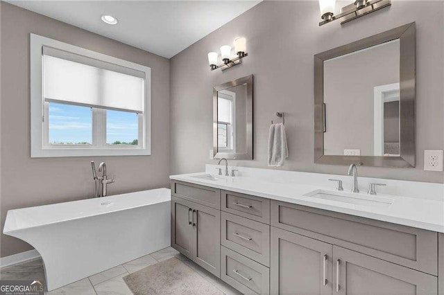 bathroom with vanity and a tub