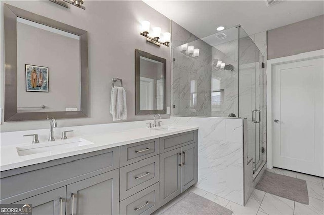 bathroom with vanity and a shower with door