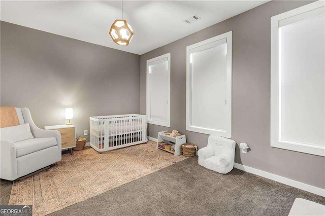 carpeted bedroom with a nursery area