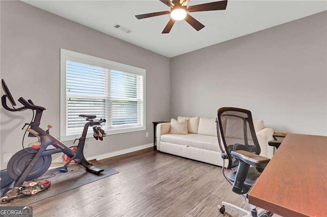 home office featuring wood-type flooring and ceiling fan