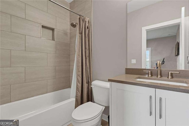 full bathroom featuring vanity, shower / tub combo, and toilet