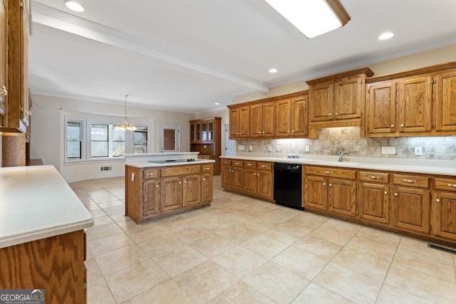 kitchen with crown molding, decorative light fixtures, a center island, black appliances, and backsplash