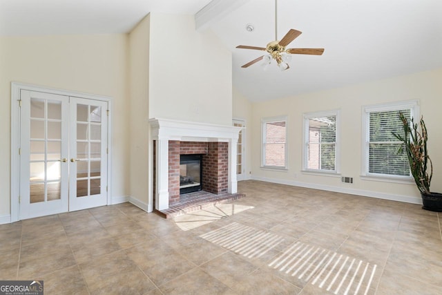 unfurnished living room featuring french doors, high vaulted ceiling, a brick fireplace, ceiling fan, and beam ceiling