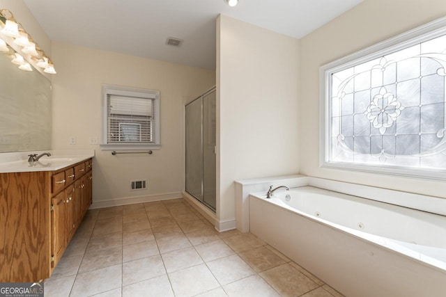 bathroom with tile patterned floors, vanity, and separate shower and tub