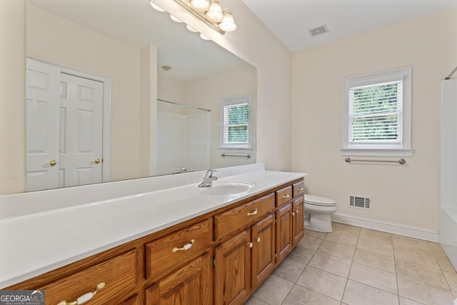 bathroom featuring tile patterned flooring, vanity, a shower, and toilet