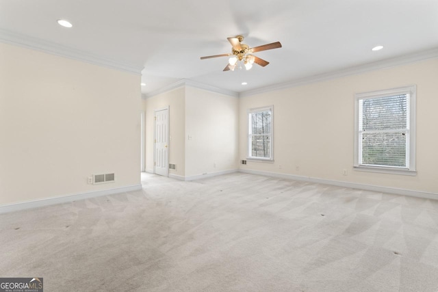 carpeted spare room featuring crown molding, plenty of natural light, and ceiling fan