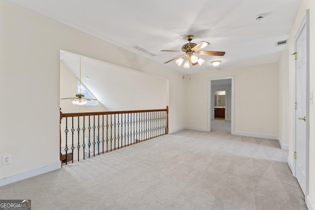 carpeted spare room featuring ceiling fan