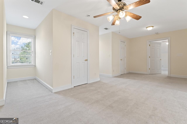 carpeted empty room featuring ceiling fan