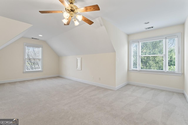 additional living space featuring ceiling fan, vaulted ceiling, and light carpet