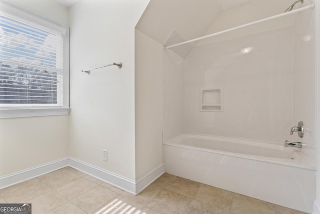 bathroom featuring shower / bathtub combination and vaulted ceiling