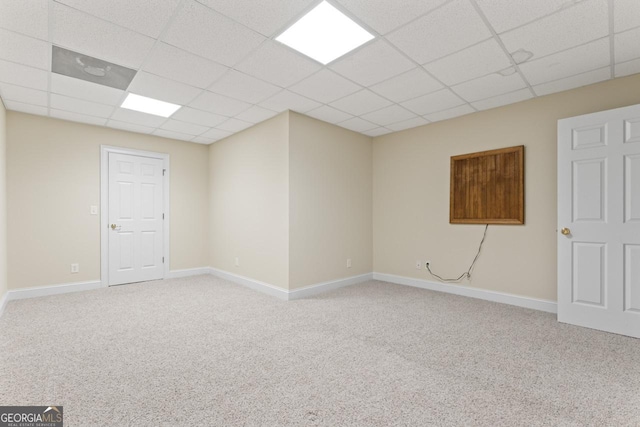 carpeted spare room featuring a paneled ceiling