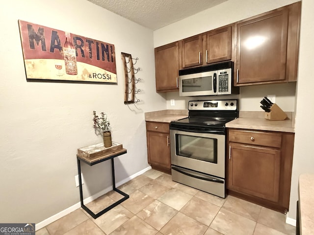 kitchen with stainless steel appliances and a textured ceiling