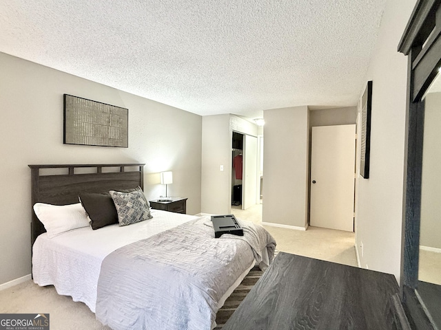 carpeted bedroom with a closet and a textured ceiling