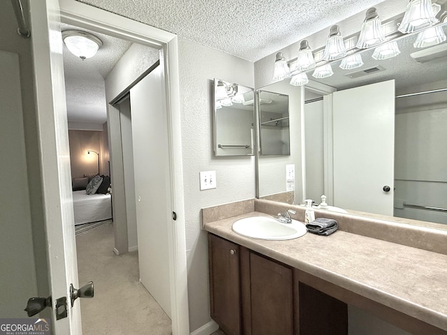 bathroom with vanity and a textured ceiling