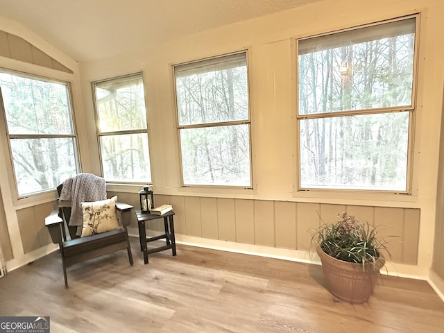 sunroom / solarium featuring a wealth of natural light and vaulted ceiling