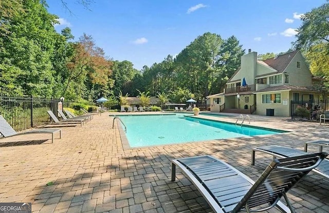 view of swimming pool with a patio