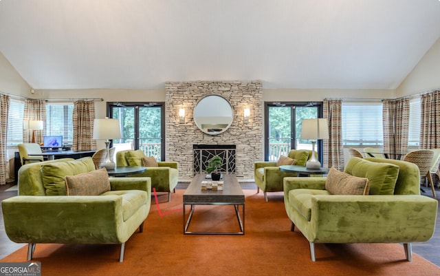 living room featuring hardwood / wood-style flooring, lofted ceiling, a fireplace, and a wealth of natural light