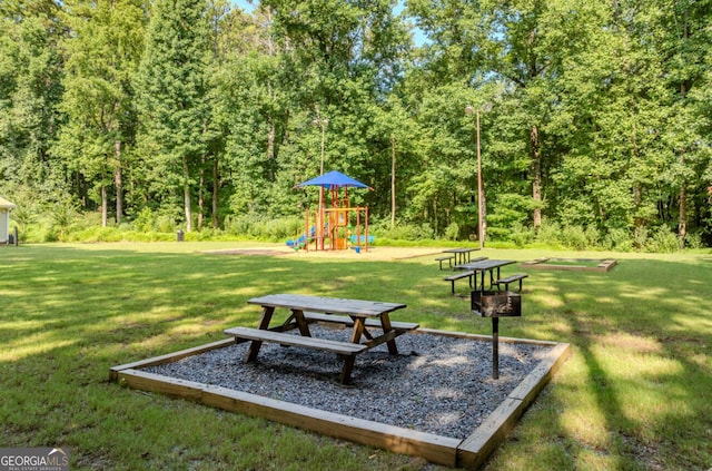 view of home's community featuring a playground and a lawn