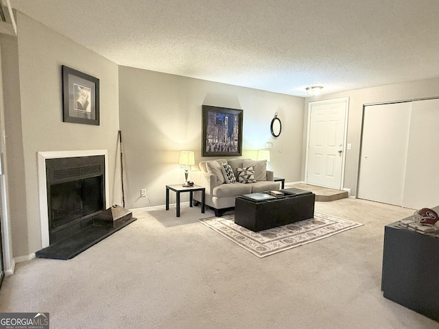 carpeted living room featuring a textured ceiling