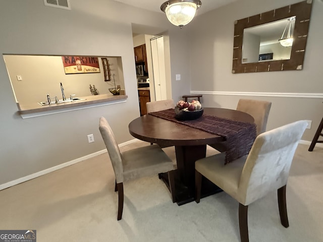 dining room with light colored carpet