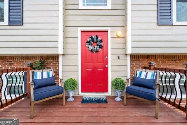 view of exterior entry featuring a wooden deck