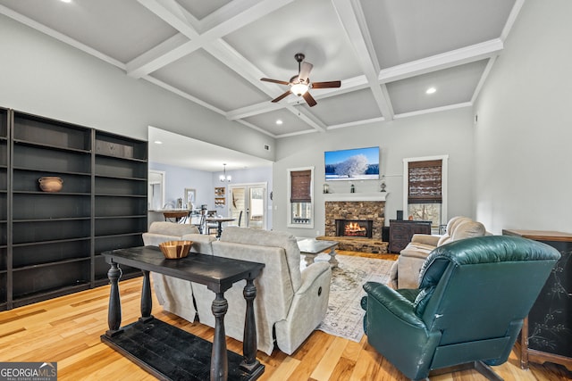 living room with coffered ceiling, beam ceiling, and light hardwood / wood-style flooring