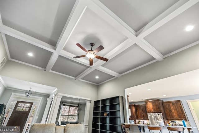 room details featuring crown molding, high end fridge, decorative columns, coffered ceiling, and beamed ceiling