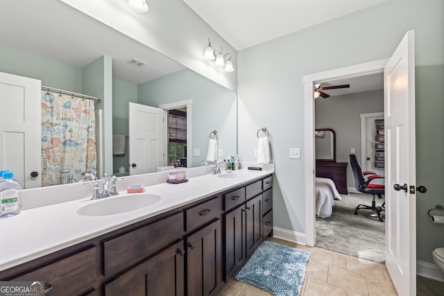 bathroom featuring tile patterned flooring, vanity, ceiling fan, and toilet