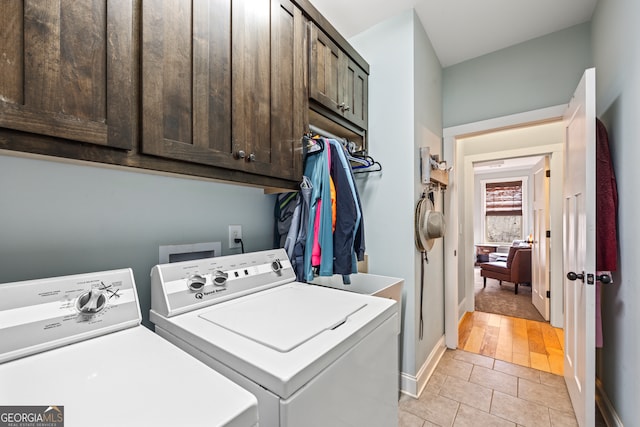 washroom featuring light tile patterned flooring, cabinets, and separate washer and dryer