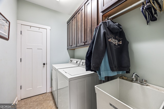 clothes washing area featuring cabinets, sink, light tile patterned floors, and independent washer and dryer