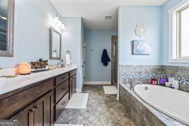 bathroom featuring independent shower and bath and vanity