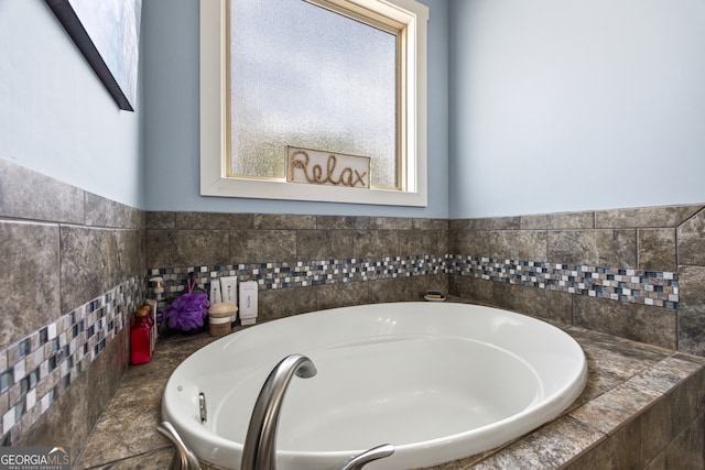 bathroom with tiled tub