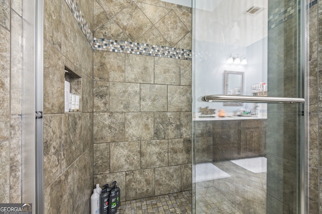 bathroom with a shower with shower door