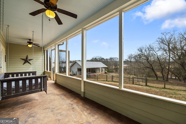 sunroom / solarium featuring ceiling fan